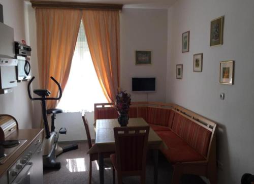a living room with a table and a couch and a window at Apartment UNA - self check in in Graz