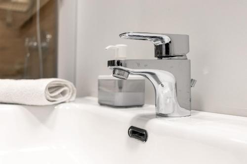 a bathroom sink with a faucet on a counter at Platinum - Il Centro Luxury Suites in Bari