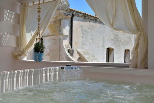 a water fountain in a room with a window at Palazzo Kapece in Monopoli