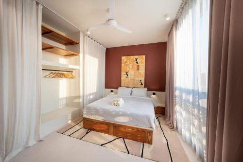 a bedroom with a bed and a bath tub at Gate 11 Spacious Apartment 1 Stylish 3rd Floor in Seminyak