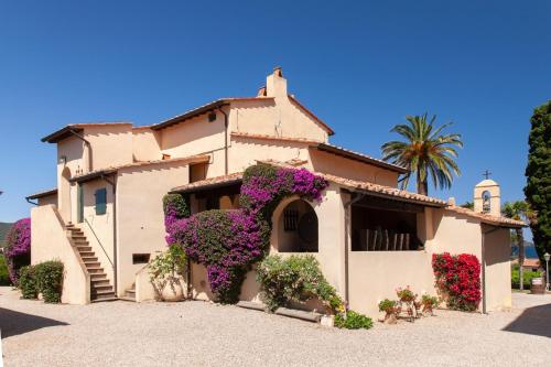a building with flowers on the side of it at Tenuta La Chiusa in Portoferraio