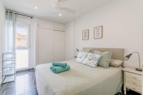 a bedroom with a bed with two pillows on it at Mar 4 en Santa Pola in Santa Pola