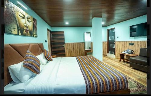 ein Schlafzimmer mit einem großen Bett und einem Fernseher in der Unterkunft Padmashree Hotel & Spa in Darjeeling