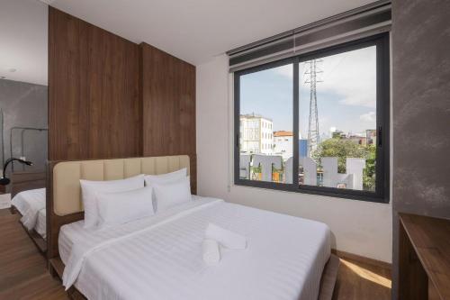 Postel nebo postele na pokoji v ubytování La Hotel Duong So 21