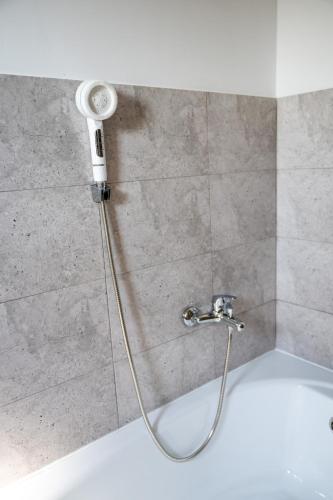 a shower with a shower head in a bathroom at Apartament de închiriat Accommodation Ap 9 in Suceava