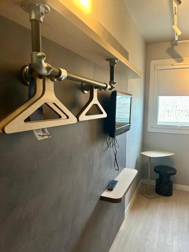 a kitchen with a hanging light on the wall at Ibis Budget Agen in Le Passage