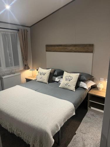 a bedroom with a bed with two pillows on it at NEW 2025 Modern 3Bedrooms Lodge Walk to Beach in Morecambe