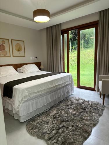 Ένα ή περισσότερα κρεβάτια σε δωμάτιο στο Praia do Forte - Mansão Sunset