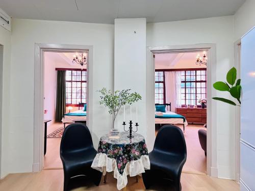 a living room with a table and chairs at Shanghai Zighouse--The Bund Premium Apartment Suites in Shanghai