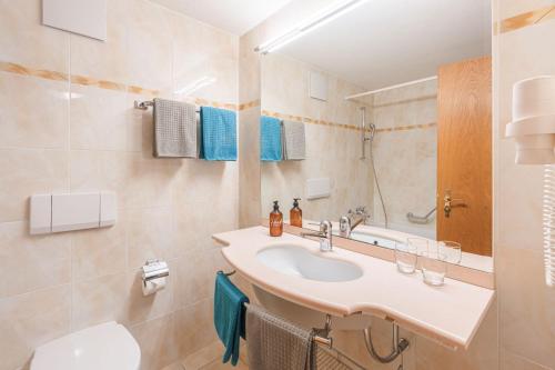 a bathroom with a sink and a toilet at Bolero Appartements in Zermatt