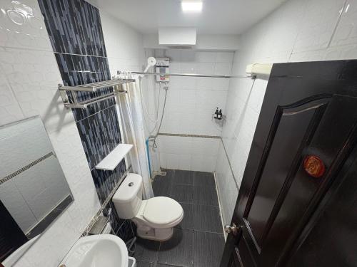 a small bathroom with a toilet and a shower at BaanPhutawanLanta in Ban Mo Nae