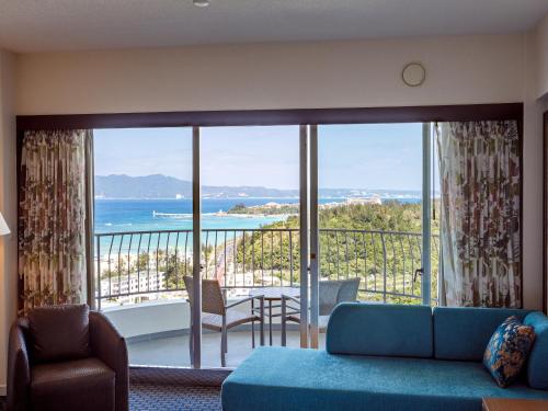 a living room with a view of the ocean at Okinawa Kariyushi Beach Resort Ocean Spa in Onna