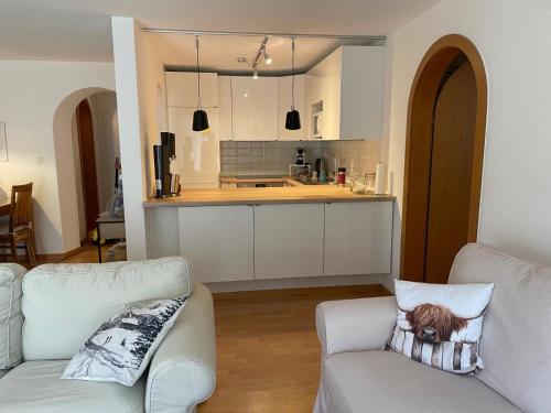 a living room with a couch and a kitchen at Cadras 14 in Tinzen