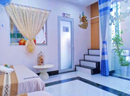 a bedroom with a bed and a sink and a staircase at Hoàng Nga Apartment Phan Thiết in Phan Thiet