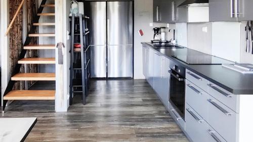a kitchen with white cabinets and a refrigerator at Simple Cabin Life In This Nature Cabin in Uvdal