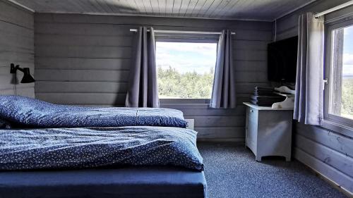 a bedroom with two beds and a window at Simple Cabin Life In This Nature Cabin in Uvdal