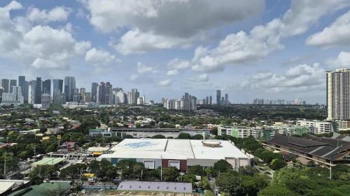 an aerial view of a city with a large building at City View with Balcony at Kasara Residences C5 Pasig in Manila