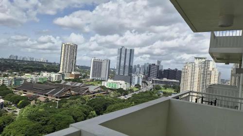 a view of a city from the balcony of a building at City View with Balcony at Kasara Residences C5 Pasig in Manila