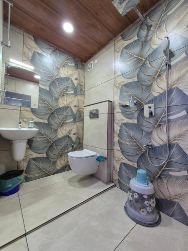a bathroom with a toilet and a sink at G Mount inn in Munnar