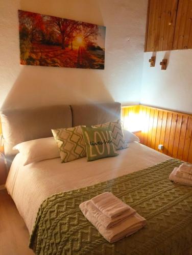 a bedroom with a bed with a towel on it at Erbanova in Sila in Camigliatello Silano