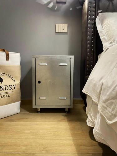 a night stand next to a bed in a room at Maison Voyage Messina in Messina
