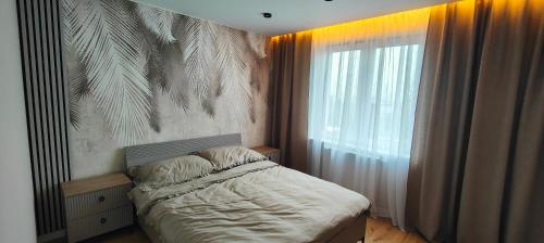 Postel nebo postele na pokoji v ubytování DArt Apartments