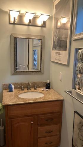 a bathroom with a sink and a mirror at Rehoboth Beach Haven in Rehoboth Beach