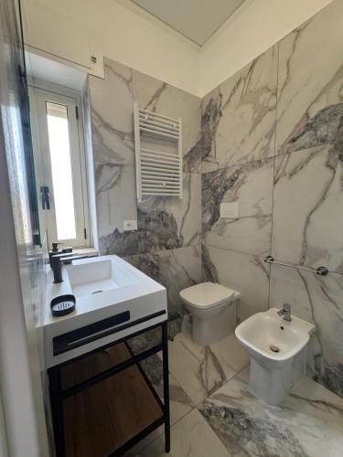 a bathroom with a sink and a toilet at Sostal5 in Chiubbica