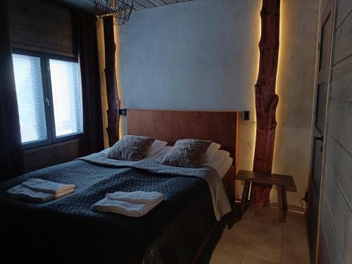 Ένα ή περισσότερα κρεβάτια σε δωμάτιο στο Rusty Reindeer Levi