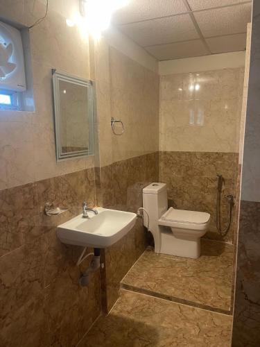 a bathroom with a sink and a toilet at Dormyy backpackers castle in Guwahati