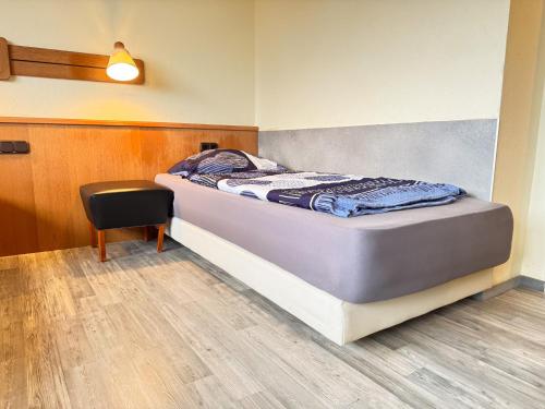 a bed in a room with a table and a chair at 33 - 12 Hotelkamer voor twee personen in Bunkenburg