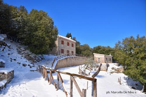 a bridge in the snow in front of a building at Rifugio Acquaviva in Formia