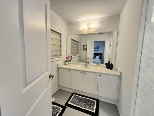 a bathroom with a sink and a mirror at First Class Ensuite Room in Brantford