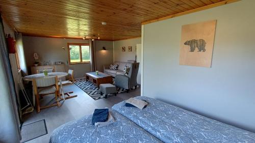 a bedroom with a bed and a living room at Abrahams Camp in Flisehult