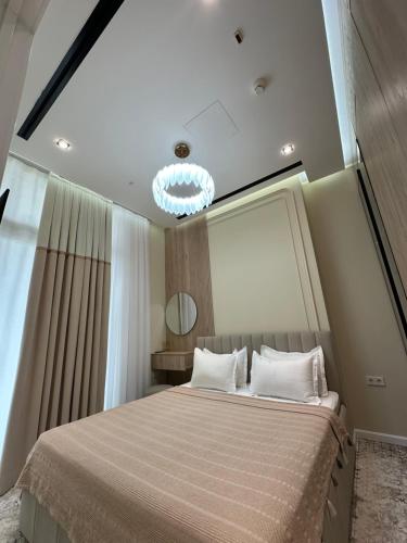 a bedroom with a large bed and a mirror at NestOne Apartment 39th floor in Tashkent
