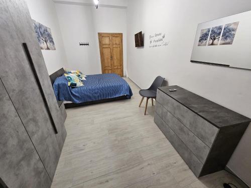a bedroom with a bed and a desk in a room at Al Vecchio Orologio in Viterbo