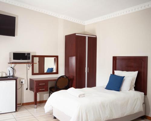 Postel nebo postele na pokoji v ubytování The Executive House