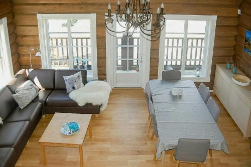 a living room with a couch and a table at Log Cabin By Mostertoppen Ski Stadium in Hafjell