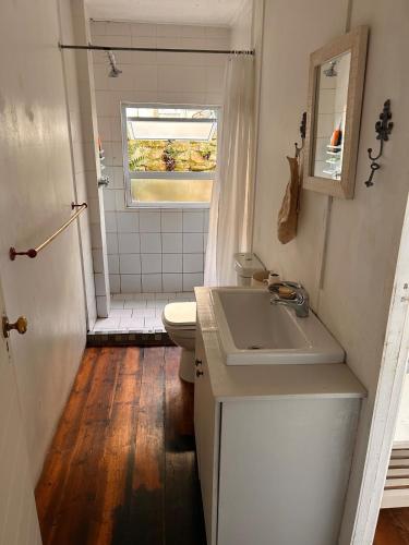 a bathroom with a sink and a toilet at Explore River Cottage Ocean View in Seafield