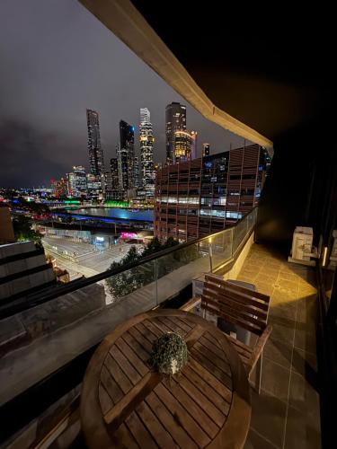 a table and chairs on a balcony with a city skyline at Melbourne Yarra View, close to Crown Casino - Moomba Fireworks in Melbourne