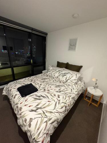 a large bed in a room with a large window at Melbourne Yarra View, close to Crown Casino - Moomba Fireworks in Melbourne