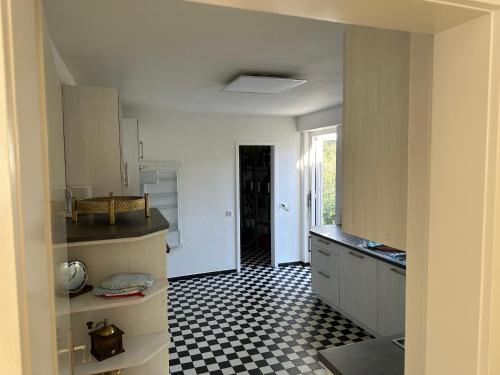 a kitchen with a black and white checkered floor at Haus Anna in Alpirsbach