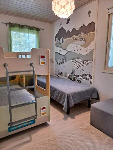 a bedroom with two bunk beds and a wall mural at Särkänhelmi in Kalajoki