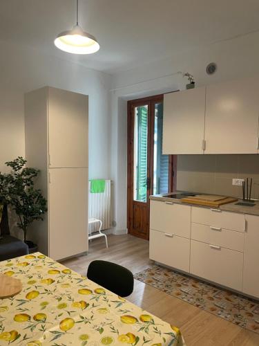 eine Küche mit weißen Schränken und einem Tisch im Zimmer in der Unterkunft Casa Rosa in Montelupo Fiorentino