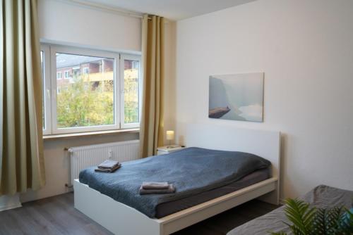 Postel nebo postele na pokoji v ubytování Moderne City Apartments im Stadtzentrum