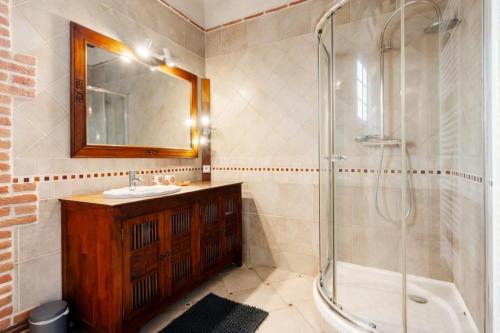 a bathroom with a shower and a sink and a tub at Gîte du Gros Hêtre in Sainte-Beuve-en-Rivière
