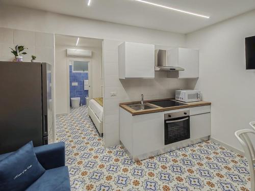 a kitchen with a sink and a stove top oven at Casa Del Duca in Salerno