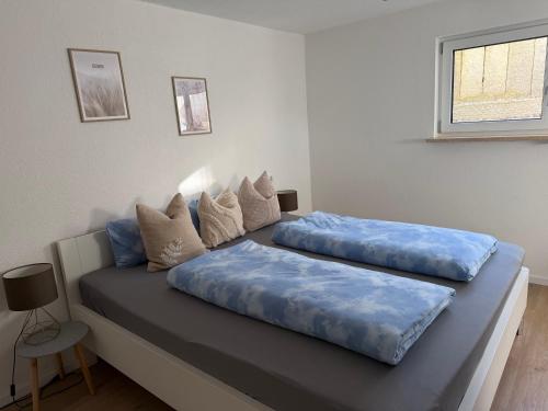 2 almohadas en una cama en una habitación en Moderne gemütliche Ferienwohnung in Friedrichshafen, en Friedrichshafen