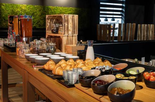 a table topped with lots of different types of food at elaya hotel kevelaer in Kevelaer