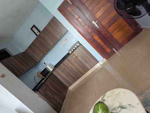 an overhead view of a bathroom with two wooden doors at Kampala suites Kisementi in Kampala
